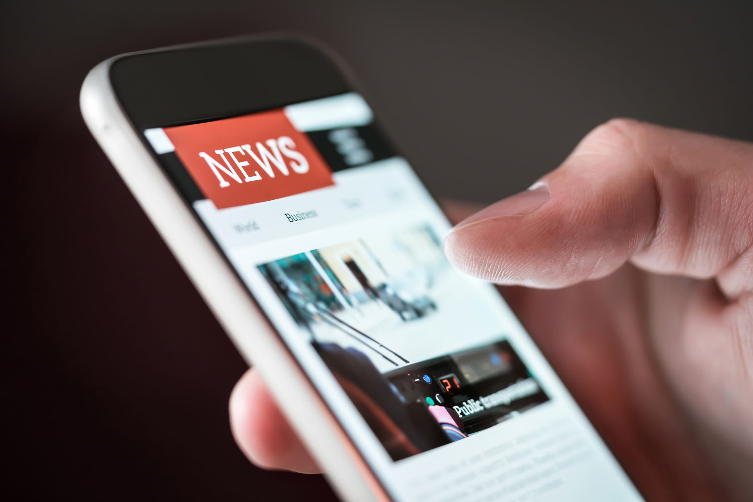 Photo of mobile phone screen showing news page